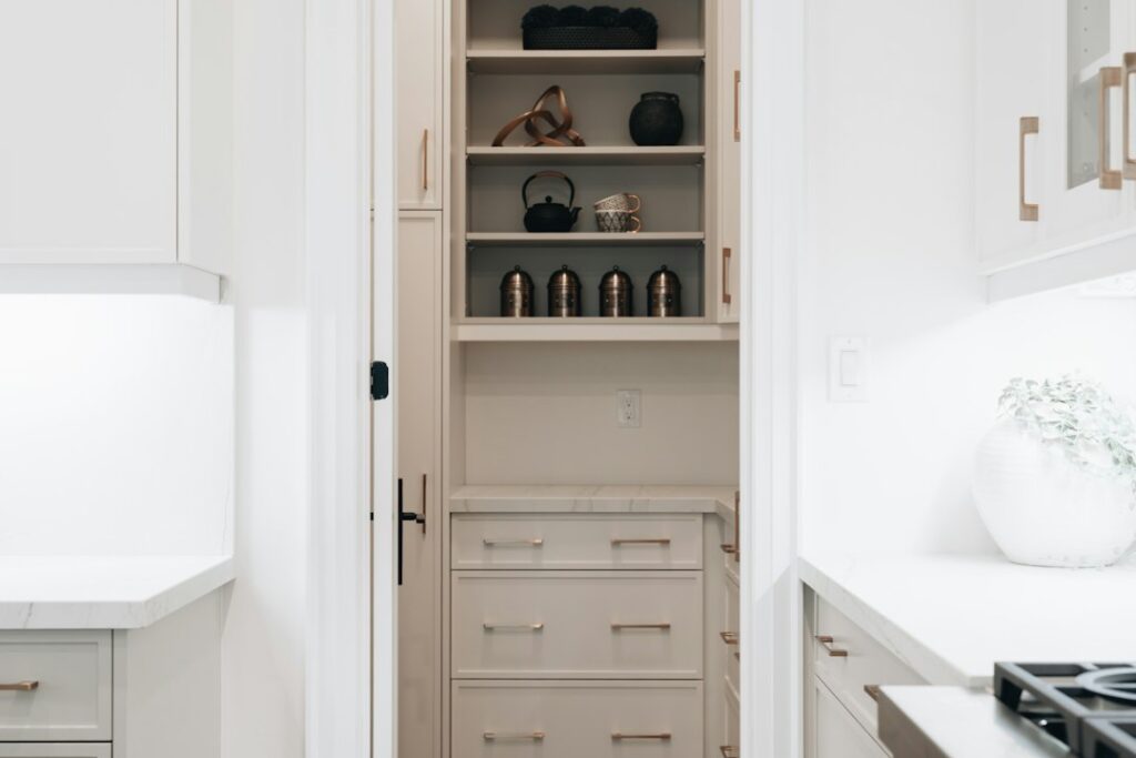 Compact kitchen with organized drawers, vertical tray storage, and neatly arranged everyday cookware.
