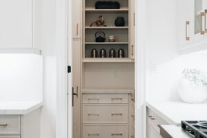 Compact kitchen with organized drawers, vertical tray storage, and neatly arranged everyday cookware.