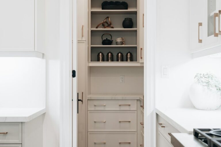 Compact kitchen with organized drawers, vertical tray storage, and neatly arranged everyday cookware.